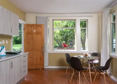 a kitchen with a table and chairs and a window at Airport Costa Rica B&B in Alajuela City