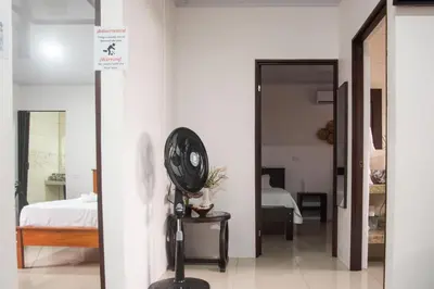 a room with a fan next to a bedroom at Casa DesKanso - La Fortuna in Fortuna