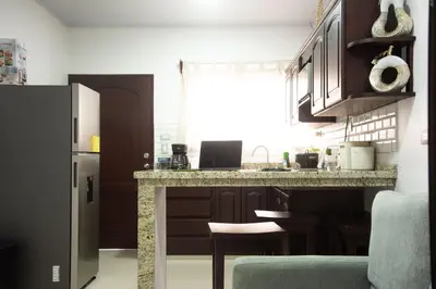 a kitchen with a counter top and a refrigerator at Casa DesKanso - La Fortuna in Fortuna