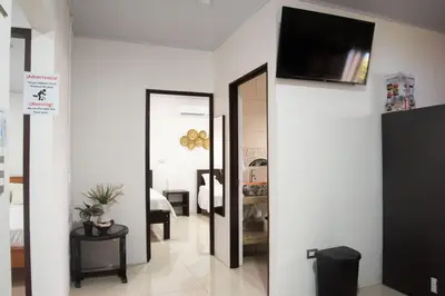 a hallway with a mirror and a television on a wall at Casa DesKanso - La Fortuna in Fortuna
