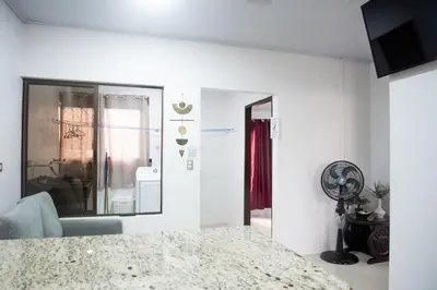a white living room with a window and a fan at Casa DesKanso - La Fortuna in Fortuna