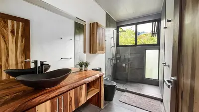 a bathroom with a sink on a wooden counter at Casa Ker Lumar in Uvita