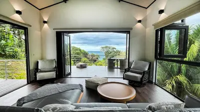 a living room with a couch and a table and chairs at Casa Ker Lumar in Uvita
