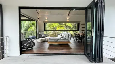 an open door to a living room with a couch at Casa Ker Lumar in Uvita