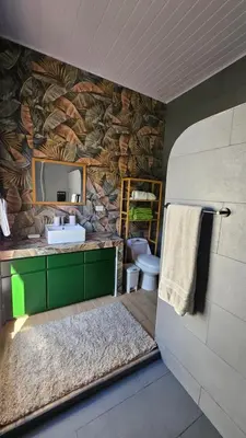 a bathroom with a sink and a mirror and a toilet at Nuevo Leones, #50 in Parrita