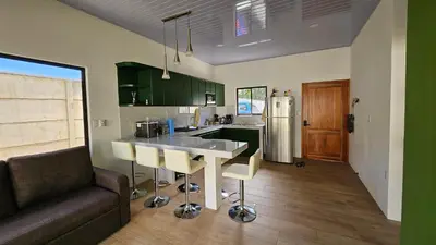 a kitchen with a table and a couch in a room at Nuevo Leones, #50 in Parrita