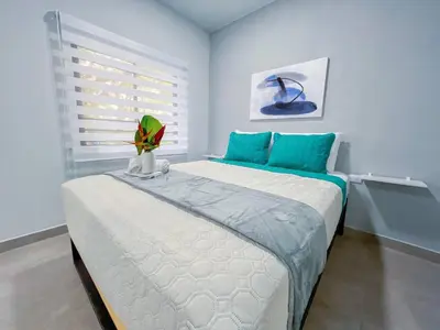 a bedroom with a bed with a green plant on it at Forest apartments studio F2, walking to the beach in Jacó