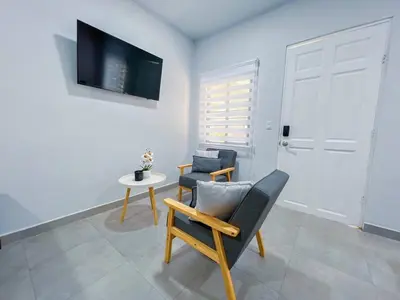 a living room with two chairs and a table at Forest apartments studio F2, walking to the beach in Jacó