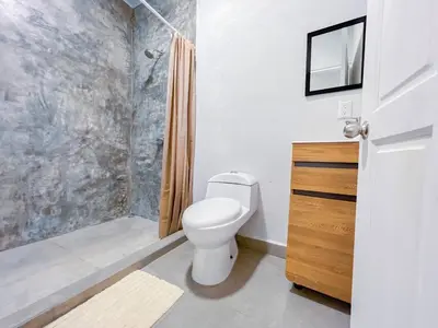 a bathroom with a toilet and a shower at Forest apartments studio F2, walking to the beach in Jacó