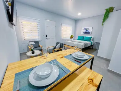 a living room with a table and a couch at Forest apartments studio F2, walking to the beach in Jacó