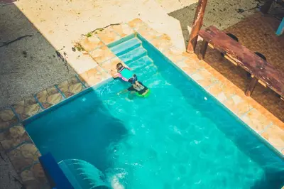 an overhead view of a person in a swimming pool at Villas Antomar in Puntarenas