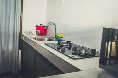 a kitchen counter with a stove and a sink at Villas Antomar in Puntarenas