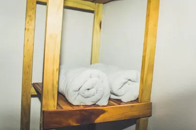 a couple of towels sitting on a wooden shelf at Villas Antomar in Puntarenas
