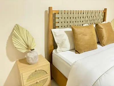a bedroom with two beds and a table with a vase at Arenal by the river in San Francisco