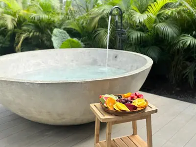 a bowl of fruit on a wooden stand next to a tub at Arenal by the river in San Francisco