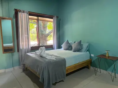 a blue bedroom with a bed and a window at Casas DiTi in Santa Cruz