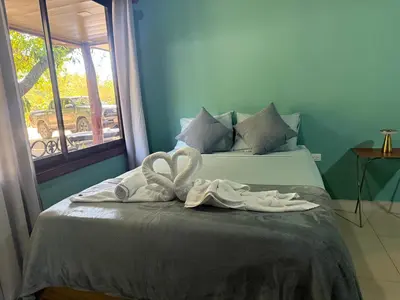 two towels on a bed with a window at Casas DiTi in Santa Cruz