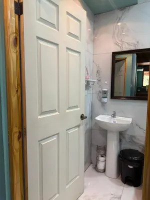 a bathroom with a white door and a sink at Casas DiTi in Santa Cruz