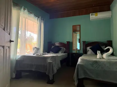 a blue room with two beds with swans on them at Casas DiTi in Santa Cruz