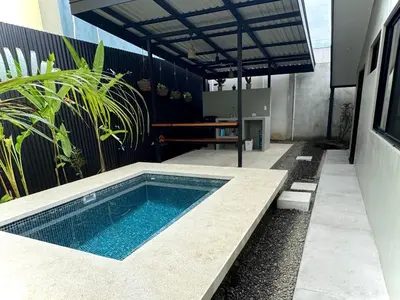a swimming pool in the middle of a patio at Private Tail House centre Uvita in Uvita