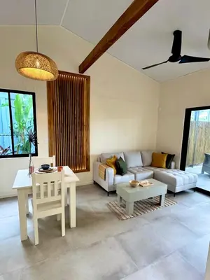 a living room with a couch and a table at Private Tail House centre Uvita in Uvita