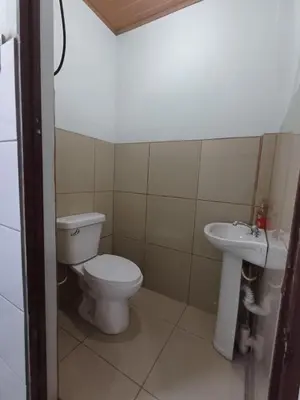 a bathroom with a toilet and a sink at Sol De Fati in Quepos