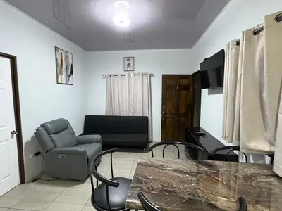 a living room with a table and chairs at Schultz Apartamento in Alajuela City