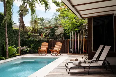 a patio with chairs and a swimming pool at Casa Bismarkia in Santa Teresa Beach