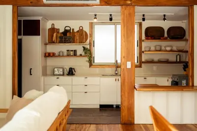 a kitchen with white cabinets and a window at Casa Bismarkia in Santa Teresa Beach