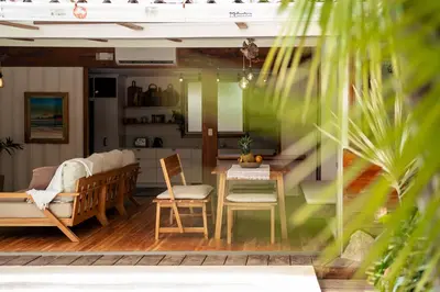 a living room with a bed and a table and chairs at Casa Bismarkia in Santa Teresa Beach