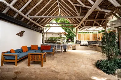 a living room with a blue couch and a table at Casa Bismarkia in Santa Teresa Beach