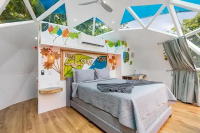 a bedroom with a bed in a room with windows at Blue Ridge Retreat in Potrero