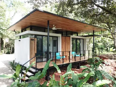 a small house with a wrap around deck at Casita Jungle Nest non active in Matapalo