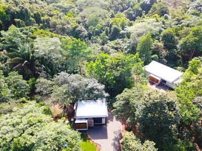 an aerial view of two buildings in a forest at Casita Jungle Nest non active in Matapalo