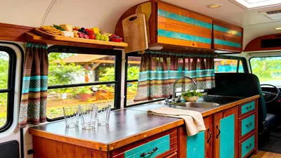 a kitchen in an rv with a sink and a counter at Bus Glamping near La Fortuna with Private Jacuzzi & Breakfast in Santa Clara