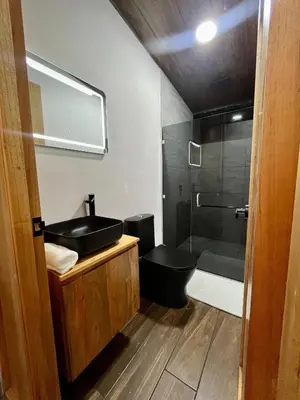 a bathroom with a black sink and a shower at Arenal Rocks in Fortuna