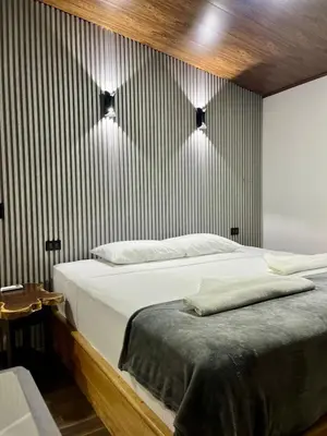 a bedroom with a bed and a striped wall at Arenal Rocks in Fortuna