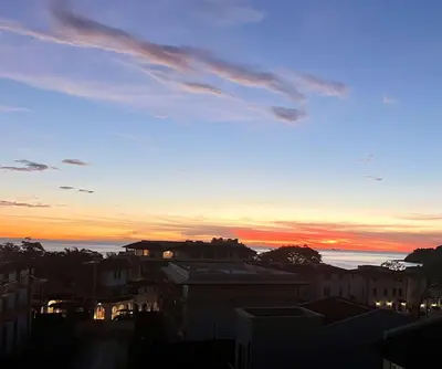 a sunset view of a city with buildings at Sophisticated Modern Home with Ocean Views, Gorgeous Master Suites & Private Jacuzzi in Playa Danta