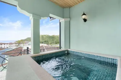 a swimming pool in a house with a balcony at Sophisticated Modern Home with Ocean Views, Gorgeous Master Suites & Private Jacuzzi in Playa Danta