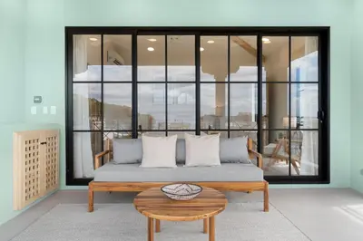 a bed in a room with a large window at Sophisticated Modern Home with Ocean Views, Gorgeous Master Suites & Private Jacuzzi in Playa Danta