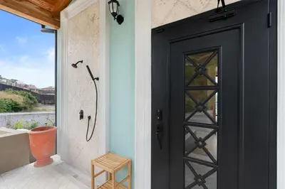 a black door in a room with a window at Sophisticated Modern Home with Ocean Views, Gorgeous Master Suites & Private Jacuzzi in Playa Danta