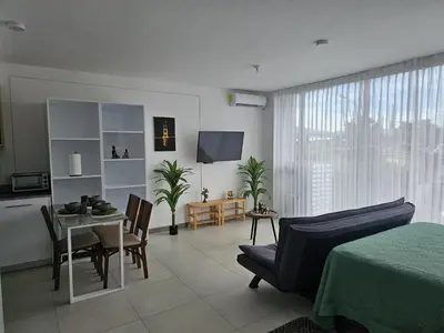 a living room with a table and a dining room at Tropical Vista iFreses, 2nd floor! AC, TV and Pool in Guayabos