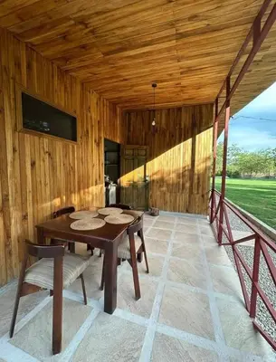 a wooden room with a wooden table and chairs at Casa Elora in Bagaces