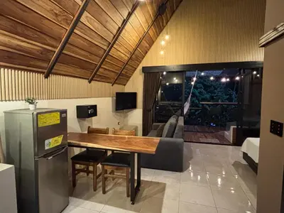 a dining room with a table and a couch at River Paradise Cabin with Private Jacuzzi in Fortuna