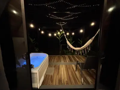 a bathroom with a hammock and a bath tub at River Paradise Cabin with Private Jacuzzi in Fortuna