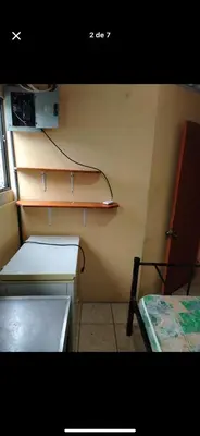 a small room with a shelf and a bed at Bryan House in Aserrí