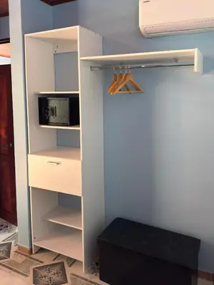a room with a white cabinet with a microwave at Hotel Carmen Costa Coral in Tambor