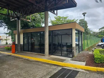 a building with glass doors on a street at 9-26 Costa Linda Jacó Beach pool view Balcony in Jacó