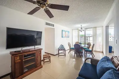 a living room with a flat screen tv and a couch at 9-26 Costa Linda Jacó Beach pool view Balcony in Jacó
