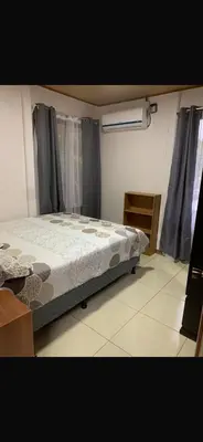 a bedroom with a bed in the middle of a room at Casa el Silencio in Arbolito